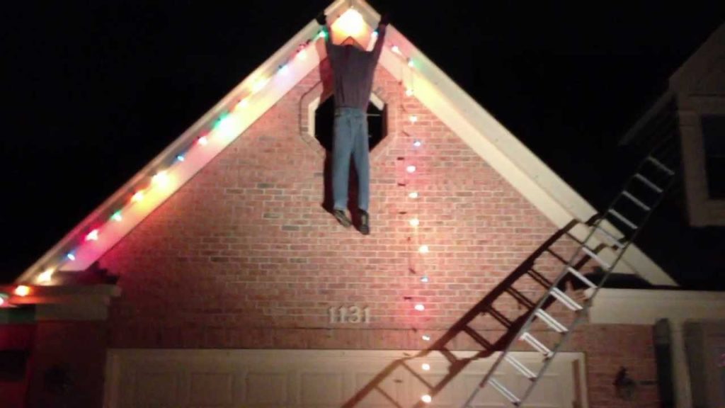 man hanging Christmas decoration