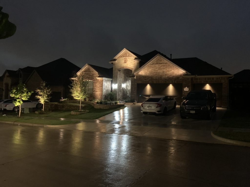 showing the safety of landscape lighting at night in the rain 