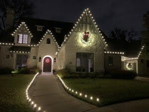 Neighbors admiring festive outdoor holiday lights and decorations
