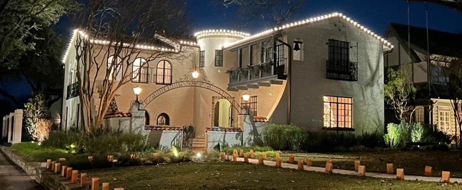 Festive Christmas lights lining a residential driveway"